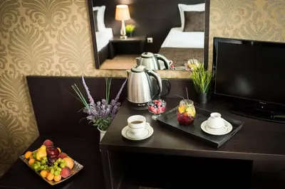 a hotel room with a table with a tray of fruit at Central Plaza in Pomorie