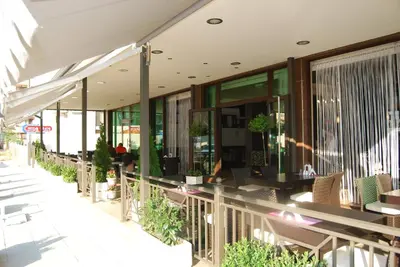 a restaurant with tables and chairs on a building at Central Plaza in Pomorie