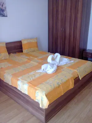 a bed with a stuffed animal sitting on top of it at Dima Popova Apartments in Tsarevo