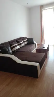 a large bed in a living room with a couch at Dima Popova Apartments in Tsarevo