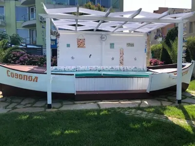 a hot tub in a backyard with a white pergola at Villa St Anna in Sozopol