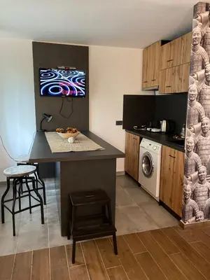 a kitchen with a island in the middle of a room at Бунгала Виктория - Камчия in Kamchia