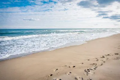 a couple of footprints in the sand on the beach at Бунгала Виктория - Камчия in Kamchia