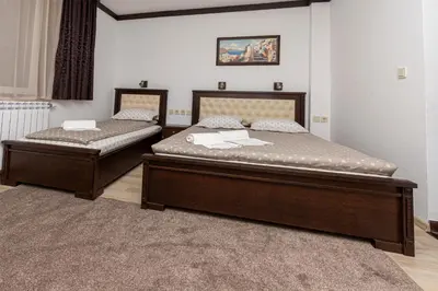 two beds sitting in a room with at Sunny Paradise ll in Kiten