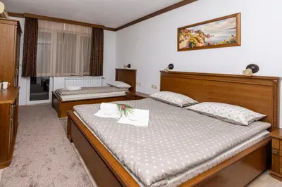 a bedroom with two twin beds and a window at Sunny Paradise ll in Kiten