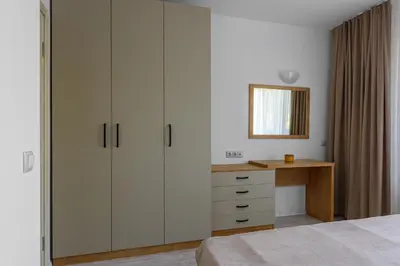 a bedroom with a desk and a large closet at Lily Beach Resort in Sozopol