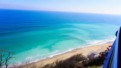 a view of a beach and the ocean from a bus at Плажни Апартаменти Силвър Бийч - Silver Beach Sea Apartments in Byala