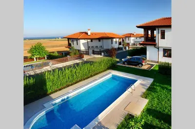 a swimming pool in the backyard of a house at Generaator House in Aheloy