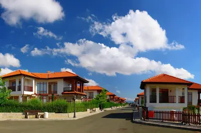 a row of houses with orange roofs on a street at Generaator House in Aheloy