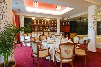 a dining room with a table and chairs and a bar at Generaator House in Aheloy
