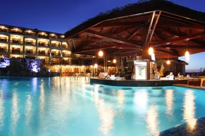 a hotel with a swimming pool at night at Generaator House in Aheloy