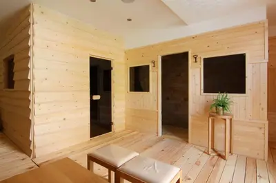 a large room with wooden walls and a television at Generaator House in Aheloy