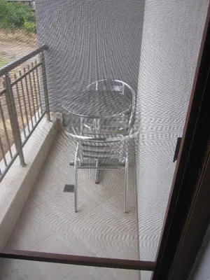 a table and a chair sitting on a balcony at Neli Sea Villa in Sozopol