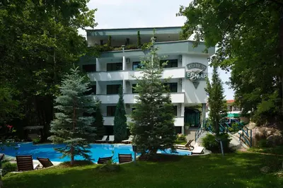 a hotel with a swimming pool and chairs and trees at Elmar Hotel in Kiten