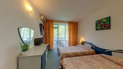 a hotel room with two beds and a mirror at Elmar Hotel in Kiten