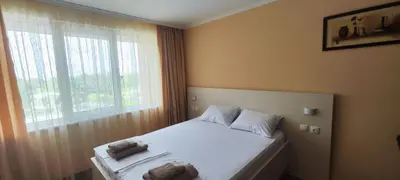 a bedroom with a bed with two towels on it at Sozopoli Hills Simeonov Apartments in Sozopol