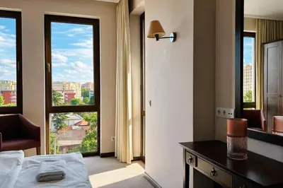 a hotel room with a bed and a large window at ROYAL BEACH - Modern & Private Apartments in center Sunny Beach in Sunny Beach