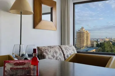 a bottle of wine on a table with a window at ROYAL BEACH - Modern & Private Apartments in center Sunny Beach in Sunny Beach