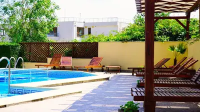 a patio with chairs and a swimming pool at Комплекс Бяла Виста до Плажа - Complex Byala Vista near the beach in Byala