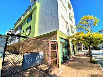 a sign on a fence in front of a building at Botabara 312 Beach Front Apartment in Pomorie