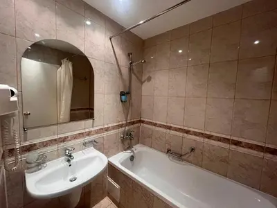 a bathroom with a sink and a tub and a mirror at Miramar Front Beach Self Catering Apartments No Swim Pool Access in Sunny Beach