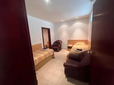 a bedroom with a bed and a couch and a chair at Miramar Front Beach Self Catering Apartments No Swim Pool Access in Sunny Beach