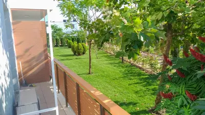 a balcony with a yard with trees and grass at Loli’s Beach Studio in Burgas City