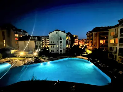 a view of a swimming pool at night at Bravo 5 Apartments in Sunny Beach