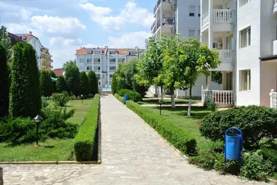 a walkway through a park in a city at Bravo 5 Apartments in Sunny Beach