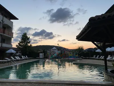 a swimming pool with a slide in a resort at MM Complex Dimitrovi in Primorsko