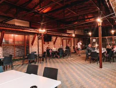 a restaurant with people sitting at tables in a room at MM Complex Dimitrovi in Primorsko
