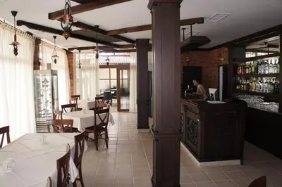 a restaurant with tables and chairs and a bar at MM Complex Dimitrovi in Primorsko