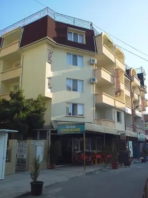 a large building on a street in front of a building at Krasi Hotel in Ravda