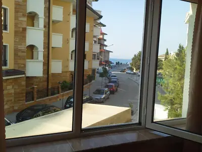 a window with a view of a city street at Krasi Hotel in Ravda