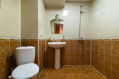 a bathroom with a toilet and a sink and a shower at Adamo Hotel in Varna City