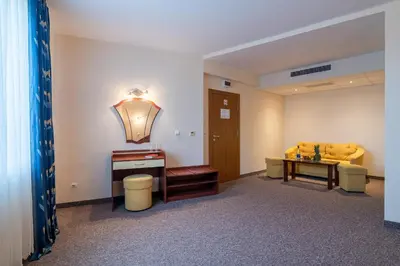 a waiting room with a couch and a table at Adamo Hotel in Varna City
