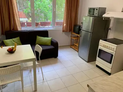 a kitchen and living room with a couch and a refrigerator at Samuil Apartments - Central Burgas in Burgas City