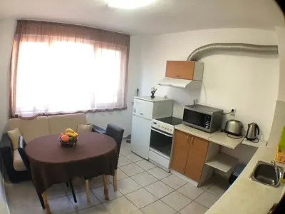 a small kitchen with a table and a small kitchen with a table and a kitchen at Samuil Apartments - Central Burgas in Burgas City