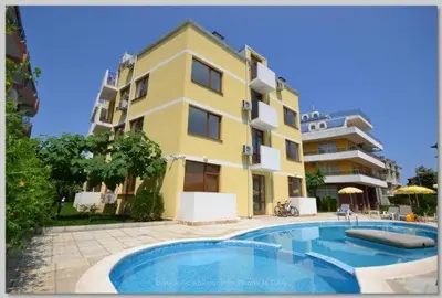 a building with a swimming pool in front of a building at SP Luxury Loft 28 in Ravda