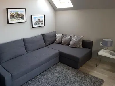 a living room with a blue couch in a room at SP Luxury Loft 28 in Ravda