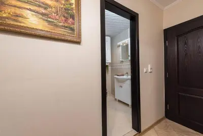 a door to a bathroom with a painting on the wall at Vazov Residence , two bedroom top centre apartment in Varna City