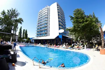 a large swimming pool with people in a building at Palace Hotel - Half Board in Sunny Beach
