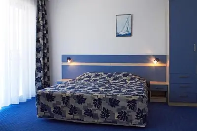 a bedroom with a bed in a blue room at Palace Hotel - Half Board in Sunny Beach