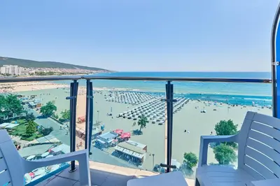 a view of a beach and the ocean from a balcony at Palace Hotel - Half Board in Sunny Beach
