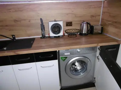a kitchen with a washing machine on a counter at Апартамент Жекови in Tsarevo