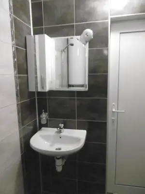 a bathroom with a sink and a mirror at Апартамент Жекови in Tsarevo