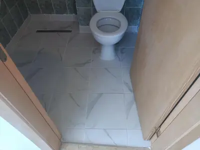 a bathroom with a white toilet in a room at Penthaus Cacao Beach in Sunny Beach