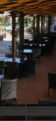 an empty restaurant with tables and chairs and tablesktop at Penthaus Cacao Beach in Sunny Beach