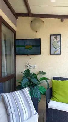a room with a couch and a plant next to a wall at Guest house Veneta in Sozopol