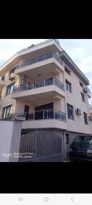 a tall building with a car parked in front of it at Guest house Veneta in Sozopol